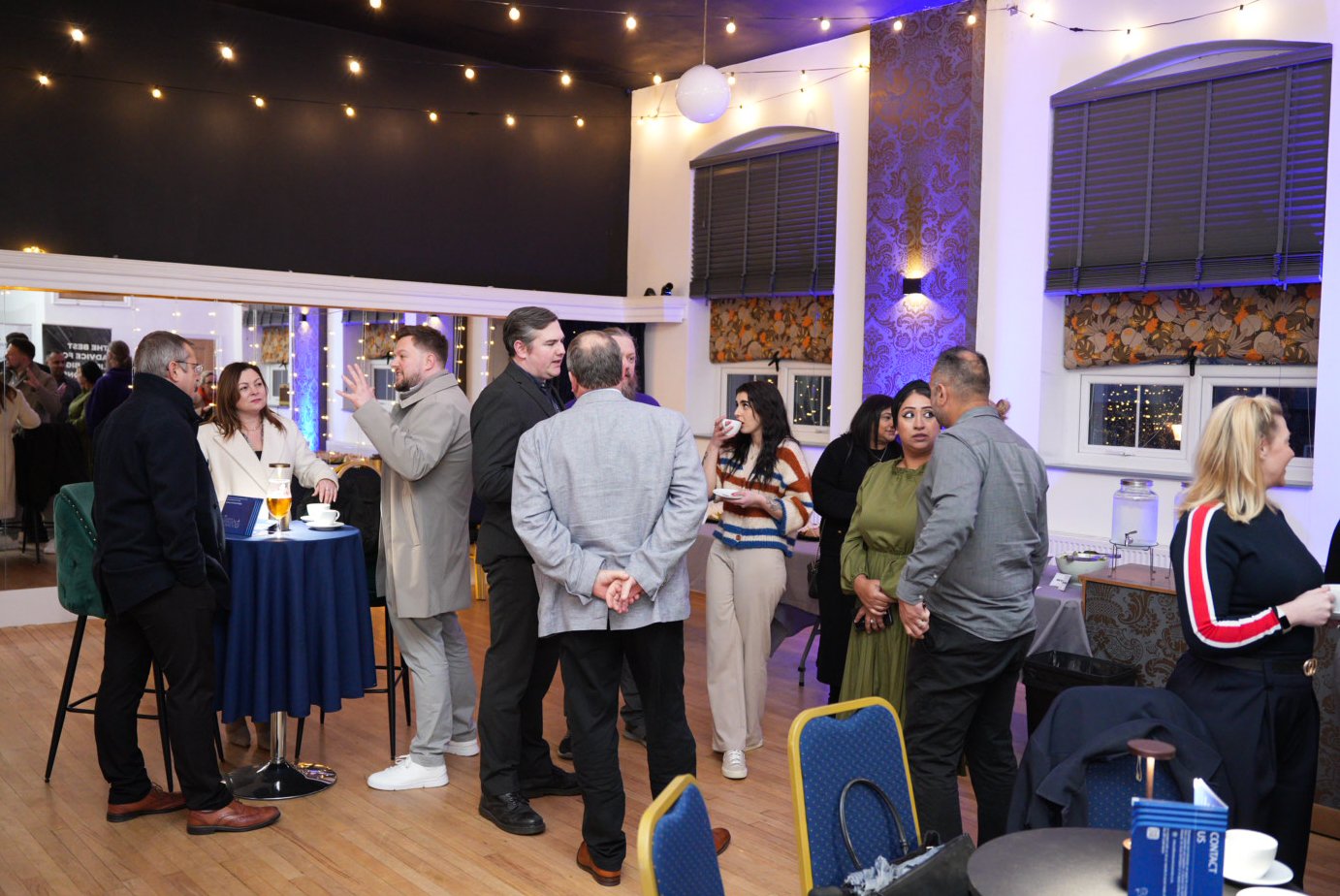 Group of people socialising at event. Group of people socialising at event.